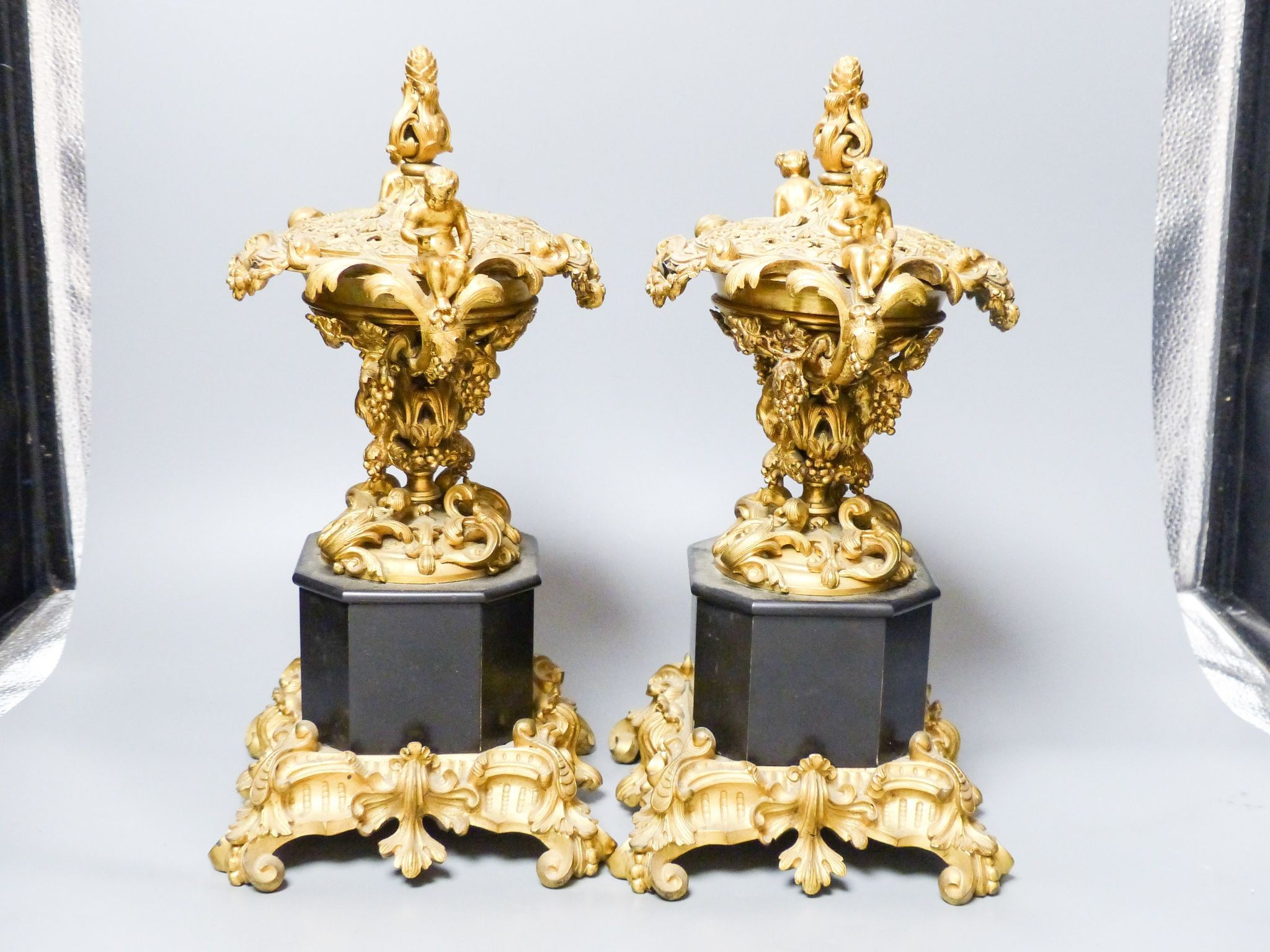 A pair of 19th century French ormolu and black marble pot pourri and covers, 34.5 cm high